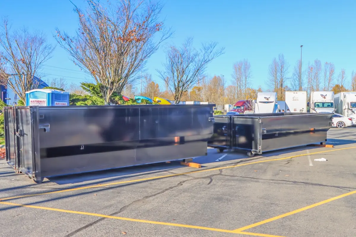 Professional dumpster rental service with roll-off container on residential driveway in Bonney Lake